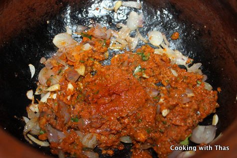 making-spicy fish curry in a clay pot
